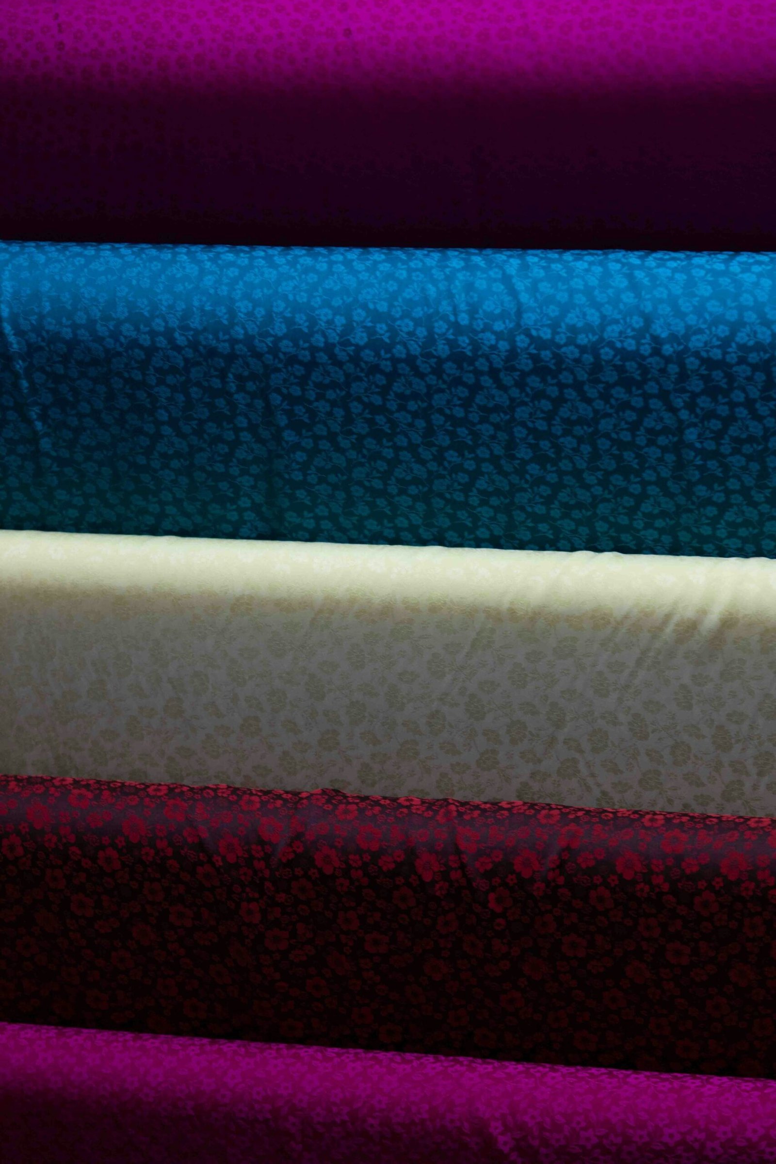 Colorful stacked rolls of fabric